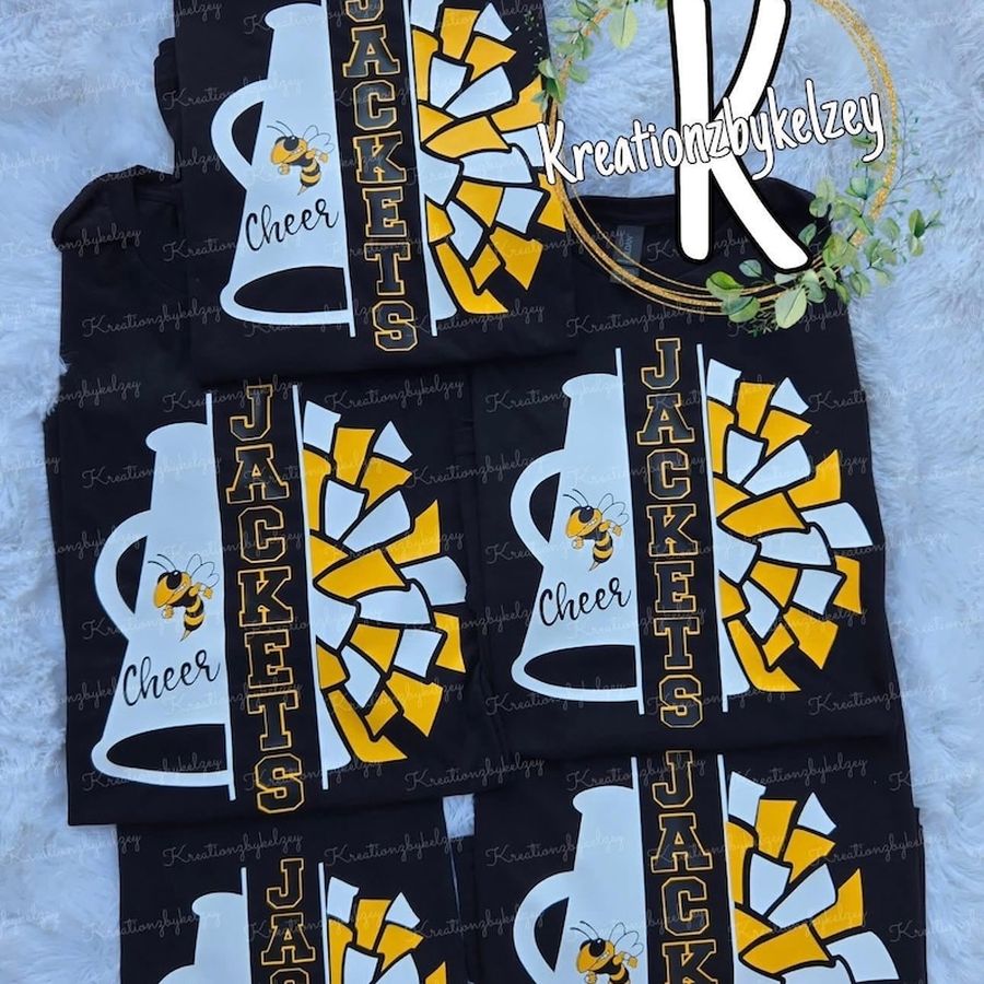 Black Jackets cheer shirts with a gold and white megaphone and pom design, stacked